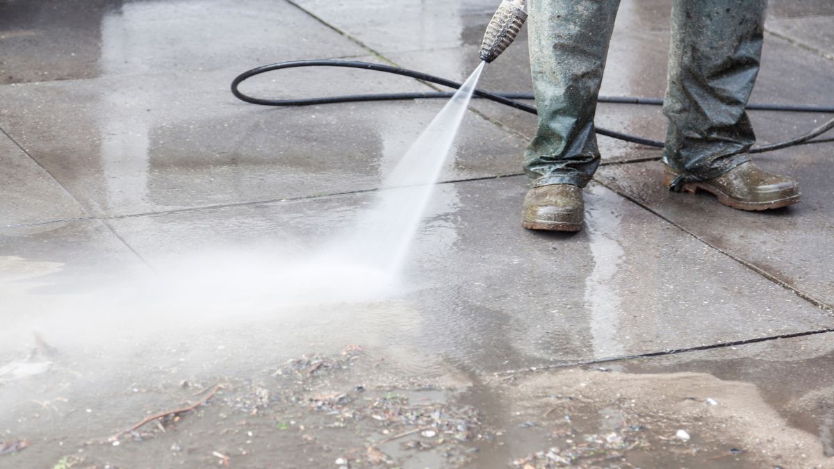 Professional pressure washing a residential driveway in Palm Beach
